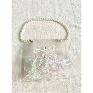 Clear pearl strap handbag with tie close